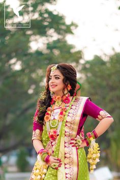 a woman in a green and yellow outfit posing for the camera with her hands on her hips