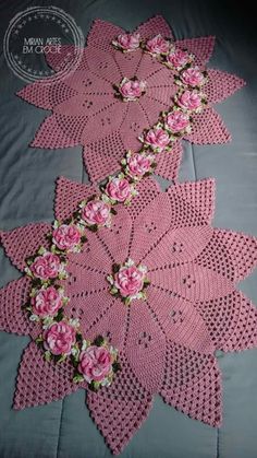 pink crocheted doily with flowers on it