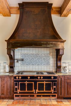 a kitchen with an oven, range and tile backsplash in the wall above it