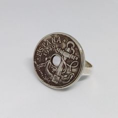 a coin ring with the word mama on it, and an anchor in the middle