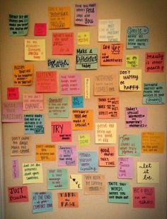 a bulletin board with many different types of notes attached to it and words written on them