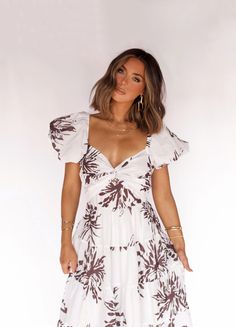 Live the island life in our Island Status Maxi Dress. With a white base adorned by tropical leaves, this dress is perfect for any vacation. Embrace the beachy vibes and feel your best in this flowy and stylish piece. It's a must-have for your next tropical getaway! Fabric 98% polyester, 2% spandex Lining 100% polyester Casual Flowy Dress For Beach Wedding, Casual White Beach Wedding Dress, Flowy Tropical Short Sleeve Dress, Flowy Short Sleeve Tropical Dress, White Summer Vacation Dress, White Short Sleeve Beach Dress For Vacation, Beachy White Short Sleeve Dress, White Summer Dresses For Vacation, Flowy Tropical Print Dress