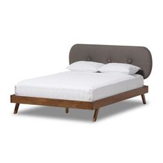 an upholstered bed with white linens and wooden legs, made to look like a headboard