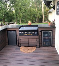 an outdoor bbq grill on a deck