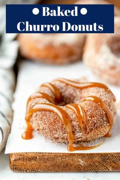 baked churro donuts with icing drizzled over them on a cutting board