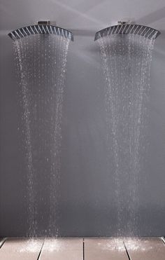 two shower heads are sprinkled with water