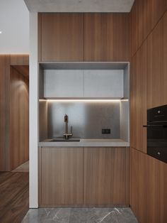 an empty kitchen with wooden cabinets and marble counter tops