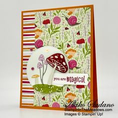 a card with mushrooms and flowers on it