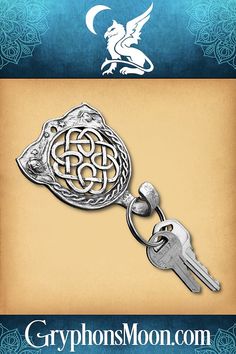 a metal keychain with an ornate design on it