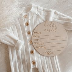 a baby's personalized cardigan with a name tag attached to the front