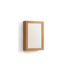 a mirror mounted on the wall next to a white wall with a wooden frame around it