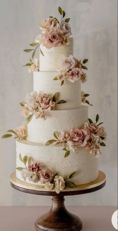 a three tiered cake with flowers on it