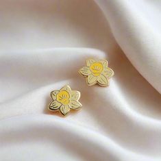 Yellow Daffodil earrings bring a burst of spring cheer no matter the season, capturing the sunny essence of these beloved blooms. Perfect for brightening up your look and your day! Enamel earring with polished gold-plated metal, featuring stainless steel posts with 0.5" (13 mm) extra-long design for secure, stable wear, paired with silicone cone backs for a snug fit. Features 10x6mm full-cover, dust-proof studs. Details: * One pair of stud earrings * Polished gold-plated metal 0.5" tall * Stainl Daffodil Earrings, Plant Earrings, Nickel Allergy, Yellow Daffodils, Earrings Flower, Enamel Earrings, Pin Backs, Daffodils, Flower Earrings