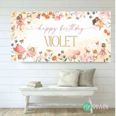 a happy birthday violett sign on a white wall with flowers and fairy figurines