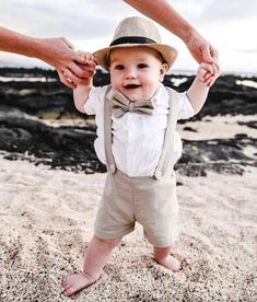 "This adorable 3 pcs. grey Christening Outfit/ Page boy outfit / wedding outfit contains of the following:  - Suspender Shorts - Beige - White Shirt - Bow tie  Suspender Shorts have a flat front waistband with elastic back and fully removable suspender straps that attach with buttons in the front and back.  The Bow Tie comes with a 5cm (approx. 2\") Velcro closure to make it an adjustable strap. Great for baby's first birthday, photo shoot, family gathering, as a Christening outfit, Page boy out Ring Boy Outfits, Boys Wedding Outfit, Linen Wedding Suit, Baby Wedding Outfit, Ring Bearer Suit, Ring Bearer Boy, Formal Wedding Suit, Wedding Outfit For Boys