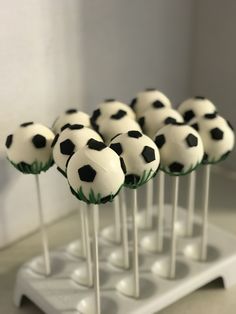 there are many soccer balls on top of each other in the cupcakes stand