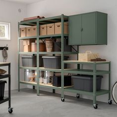 a room filled with lots of shelves and bins next to a bike parked on the floor