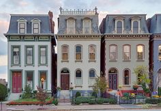 several multi - family houses are lined up on the street