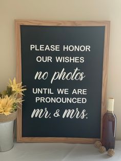 a sign that says please honor our wishes no photos until we are pronounced mr and mrs