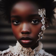 a close up of a woman's face with an elaborate head piece on her head