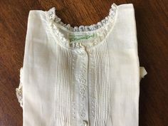 "Lovely older Feltman Brothers day dress/gown from the 1950s! Deadstock with original tissue paper and pins; a quick laundering and it is ready for your newborn! Lightweight cotton fabric with lace, embroidery, pin tucking, and tiny buttons. Very good unused condition. Overall length approximately 16\". Thanks for stopping by SOB-SouthOfBrimfield! For even more retro fun, please visit ModDesign68.Etsy.com." Vintage Cotton Dress For Wedding, White Cotton Vintage Wedding Dress, Vintage White Dresses For Church, Vintage Sleeveless Dress For Baptism, White Vintage Dress With Buttons, Vintage White Dress With Buttons, Vintage White Dress For Church, Vintage White Church Dress, Vintage White Buttoned Dress