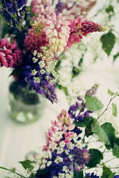 several different colored flowers in a glass vase