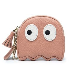 a pink coin purse with eyes and tassels