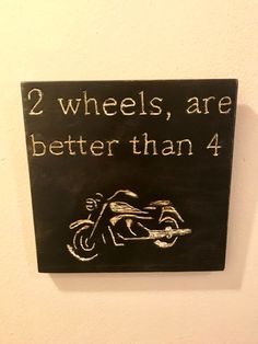 a sign that says 2 wheels, are better than 4 on the side of a wall