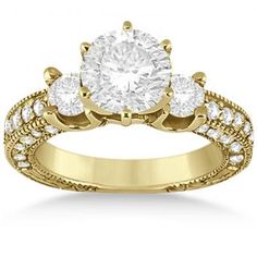 an engagement ring with three stones in the center and two diamonds on each side,