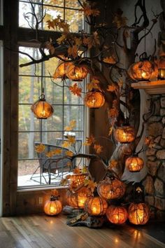 a tree with lanterns hanging from it's branches in front of a large window