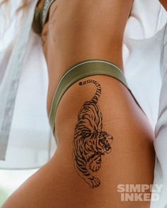 a woman with a tiger tattoo on her thigh