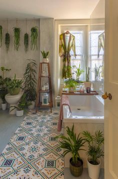 the bathroom is decorated with plants and potted plants