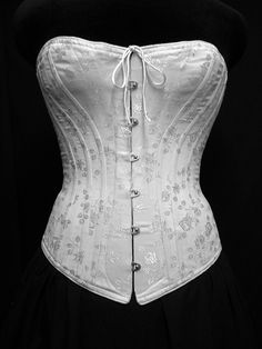 "Our c. 1880 Alice Victorian corset is designed to be worn with the long, close-fitting cuirasse bodices of the 1880s. Ideal shaping when worn with your Victorian costumes and Victorian clothing or for a bridal corset. Either worn alone as part of your wedding dress or as an undergarment this style is generously boned giving the wearing an extreme nipped in waist. Also a great addition to any Cosplay costume or Steampunk ensemble. The front panels allow a generous fullness in the bust and hips w Victorian Overbust Wedding Bodice, Victorian Overbust Wedding Corset, Elegant Historical Design Corset For Costume, Historical Underbust Corset Dress For Wedding, Victorian Bodice With Corset Back For Wedding, Victorian Wedding Bodice With Corset Back, Wedding Underbust Corset Dress With Historical Design, Elegant Fitted Corset Dress For Larp, Elegant Corset Dress For Larp