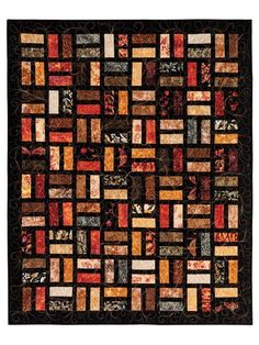 a black and orange quilt with many different squares on it's sides, including the center