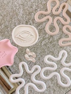 some plastic objects are laying on the floor next to books and other items that look like snakes