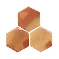 three hexagonal tiles with brown and tan colors on them, all in different sizes