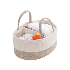 a white basket filled with baby items on top of a table