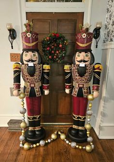 two nutcrackers standing in front of a door