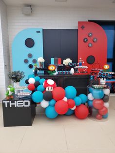 a party with balloons and mario birthday decorations