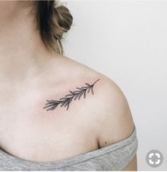 a woman's shoulder with an arrow tattoo on the left side of her chest