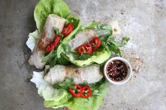 lettuce wrapped in tortilla wrappers and topped with red bell peppers