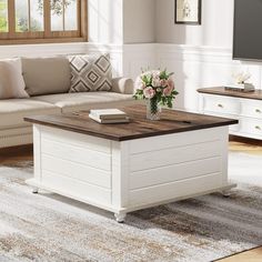 a living room filled with furniture and a flat screen tv on top of a wooden table