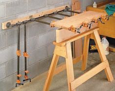 a workbench with tools attached to it sitting in front of a brick wall