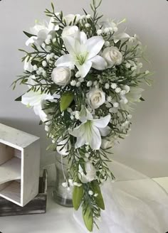 a bouquet of white flowers sitting on top of a table