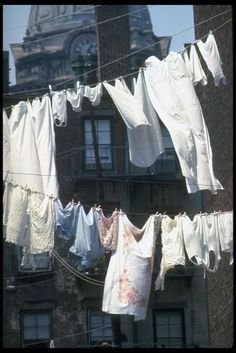 clothes hanging out to dry in front of an old building