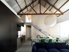 a living room filled with furniture next to a kitchen