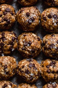 chocolate chip energy bites are piled on top of each other in the middle of a baking sheet