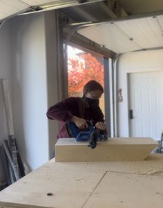 a man working on a piece of wood with a circular sawtoothing tool in his hand