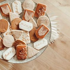 some cookies are sitting on a plate with white frosting and brown icing in the middle