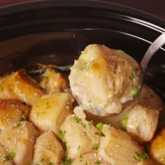 a crock pot filled with chicken and potatoes